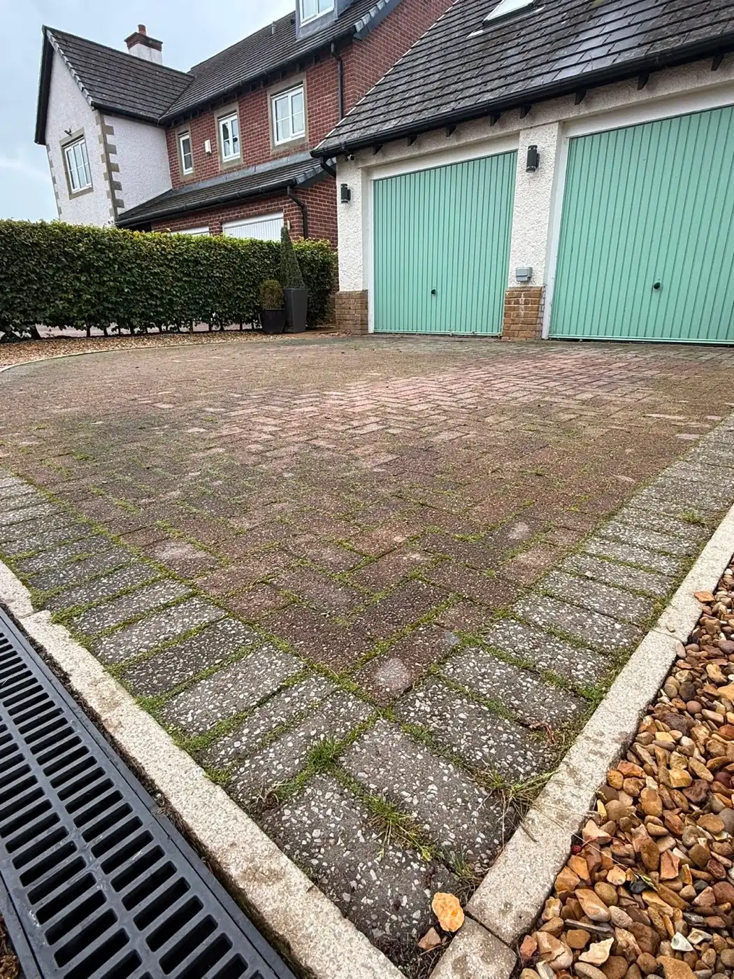 The same driveway job, showing the cleaned block paving up to the garage doors