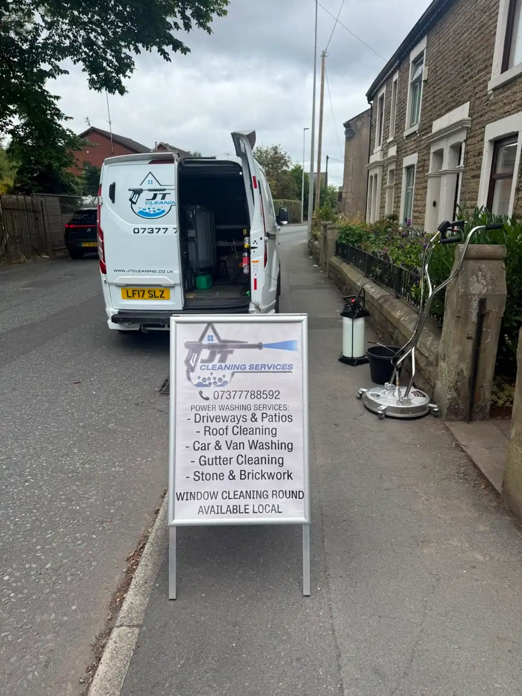 The JT Cleaning van and pavement sign on a Darwen street, rotary surface cleaner and pressure washer set up ready
