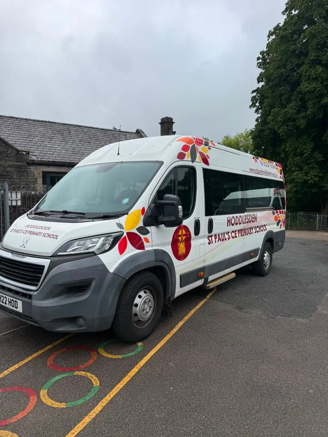A school minibus being cleaned on site at the primary school