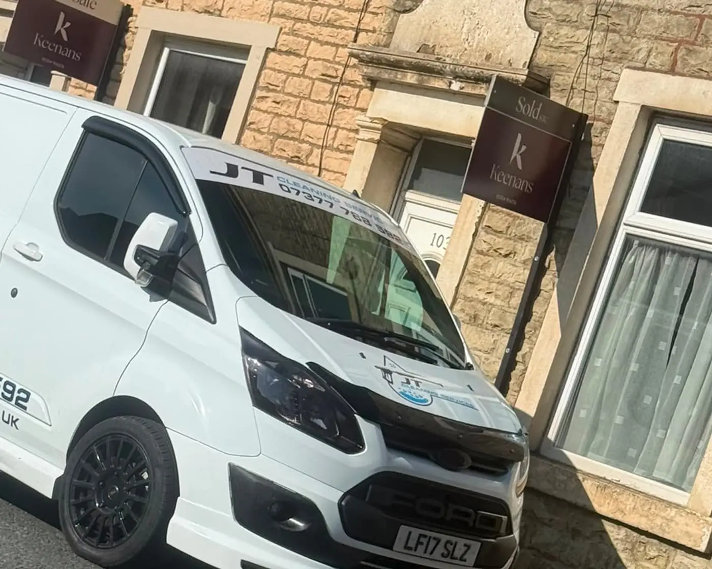 The JT Cleaning Services van parked on a stone terraced street in Darwen
